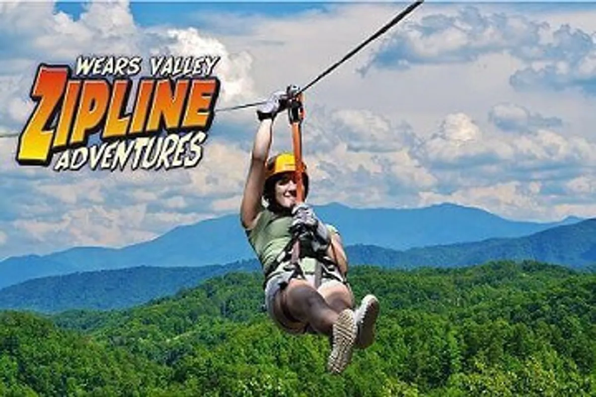 This exterior image captures a participant mid-zipline, soaring against the dramatic mountain backdrop. The vibrant action and scenic setting convey a sense of excitement and adventure.